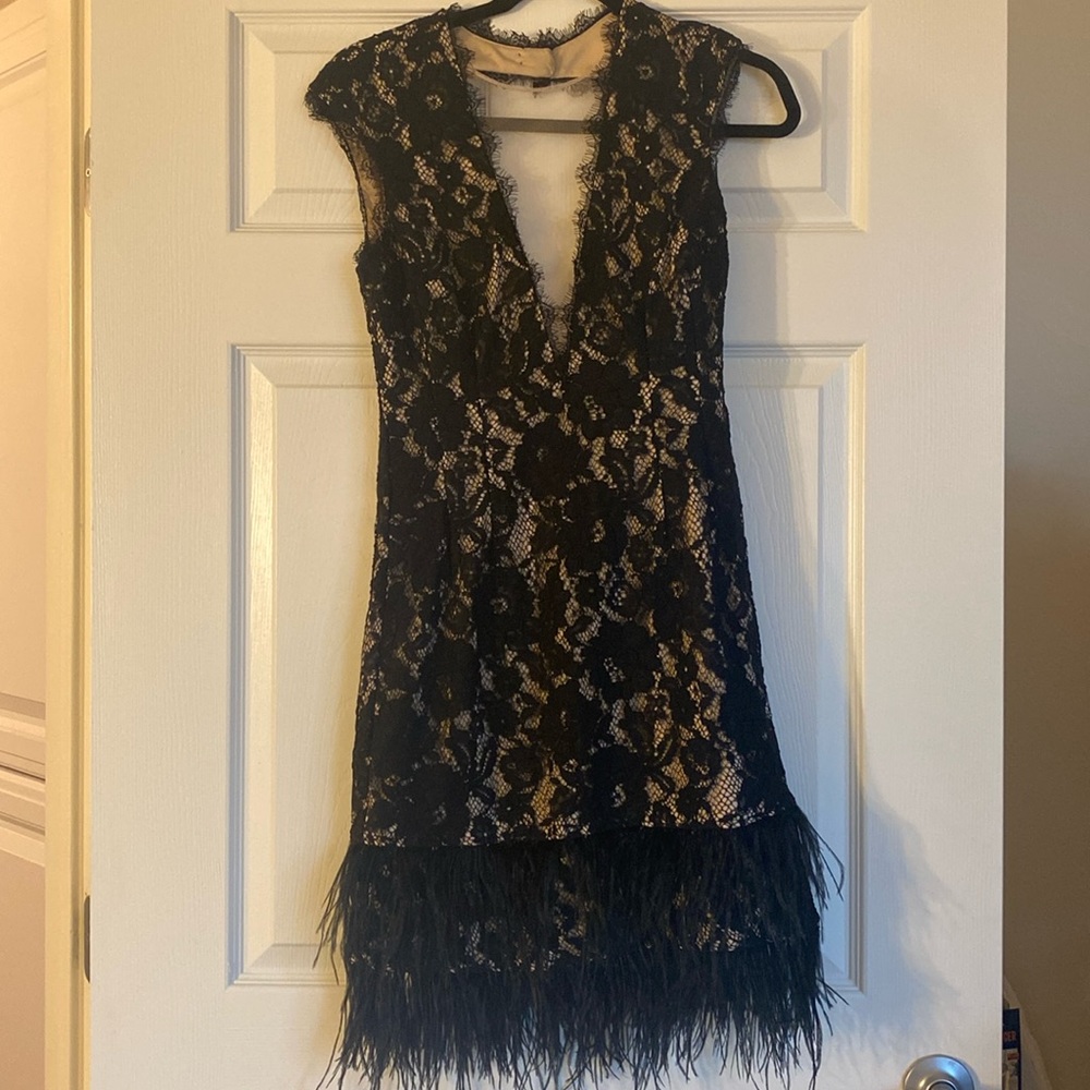 CAP SLEEVE LACE COCKTAIL DRESS WITH FEATHER TRIM IN BLACK NUDE